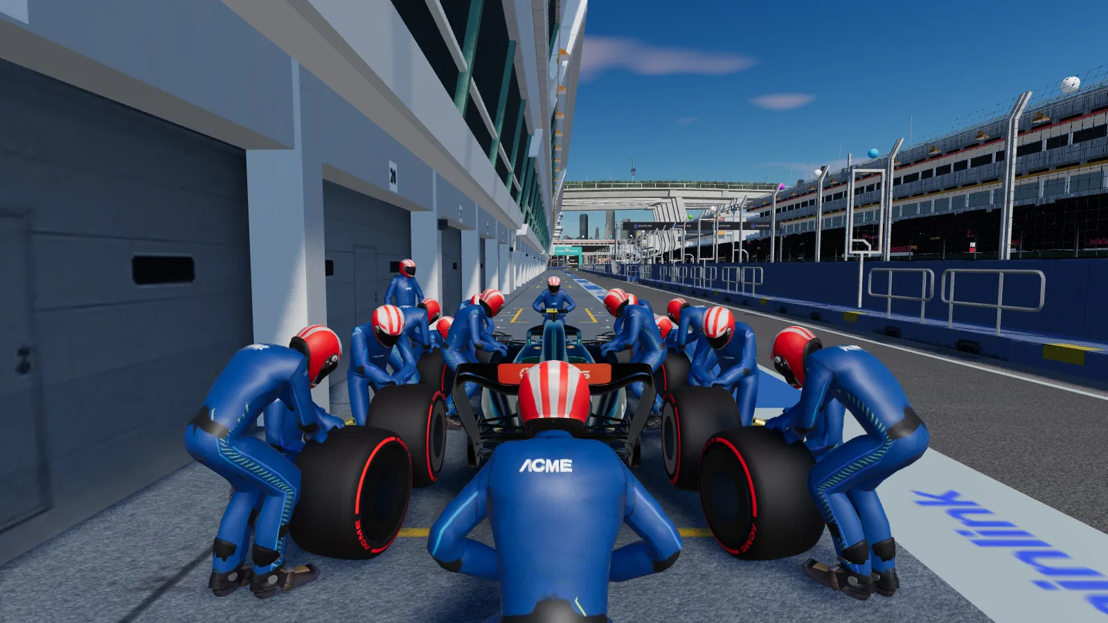 A pit crew around the car on its jacks, changing the tyres